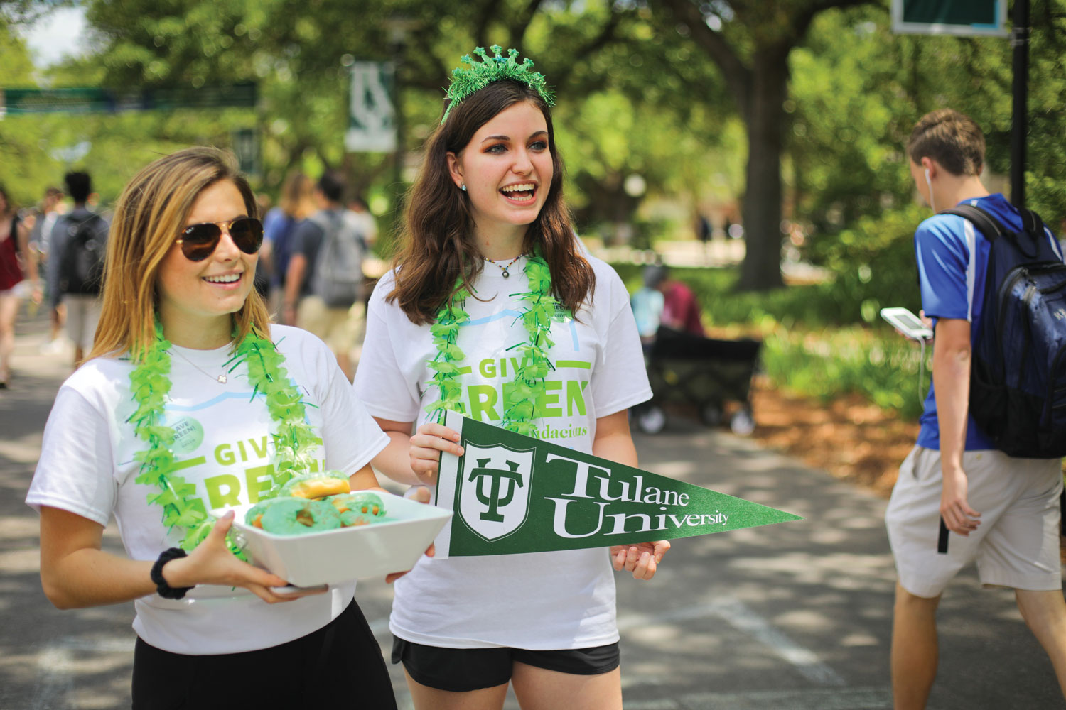 Students holding treats and a pennant Give Green 2019