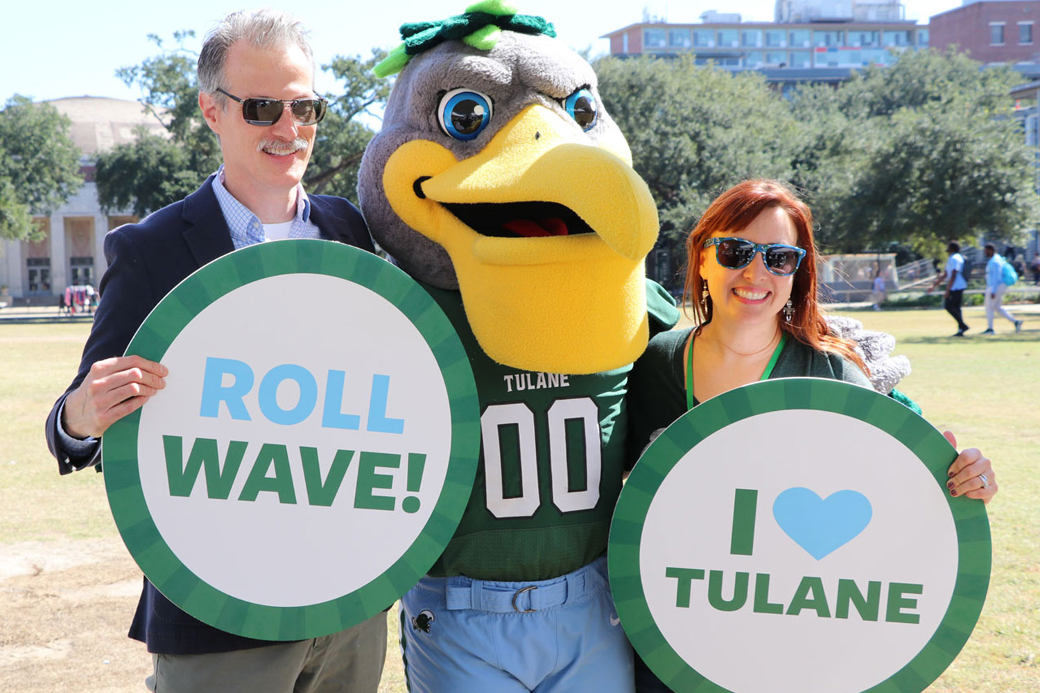 Two people holding signs with Riptide